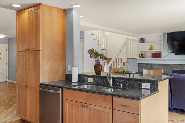 10200 Julian St, Westminster, CO 80031 - kitchen with dark stone countertops, a sink, open floor plan, light wood-style floors, and dishwasher