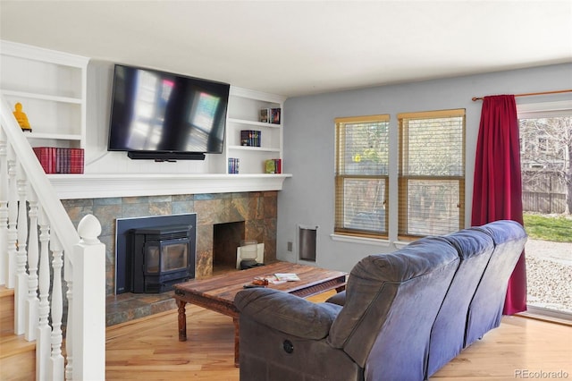 10200 Julian St, Westminster, CO 80031 - living room featuring wood finished floors, built in features, and a healthy amount of sunlight