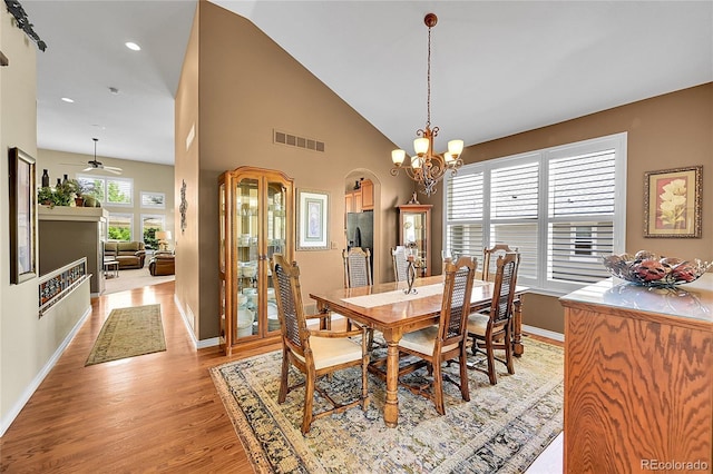 6696 S Quail Ct, Littleton, CO 80127 - dining area with light wood-type flooring, arched walkways, a chandelier, recessed lighting, and high vaulted ceiling