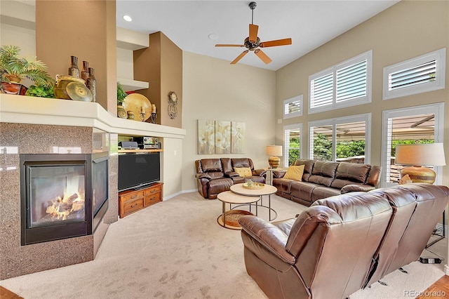 6696 S Quail Ct, Littleton, CO 80127 - living area with a multi sided fireplace, carpet, a ceiling fan, and a towering ceiling