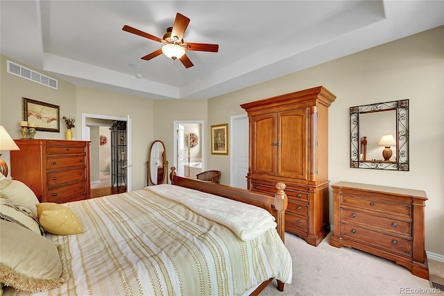 6696 S Quail Ct, Littleton, CO 80127 - bedroom with a raised ceiling, light carpet, a ceiling fan, a walk in closet, and a closet