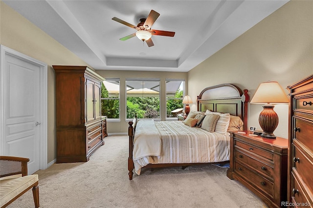 6696 S Quail Ct, Littleton, CO 80127 - bedroom featuring light carpet, a tray ceiling, and ceiling fan