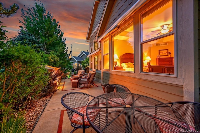 6696 S Quail Ct, Littleton, CO 80127 - patio terrace at dusk with a patio and outdoor dining area