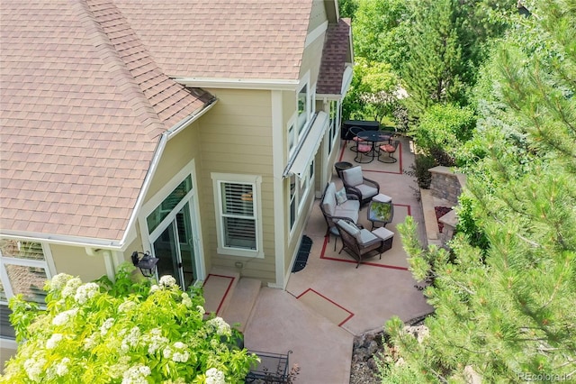 6696 S Quail Ct, Littleton, CO 80127 - view of property exterior featuring a shingled roof and a patio