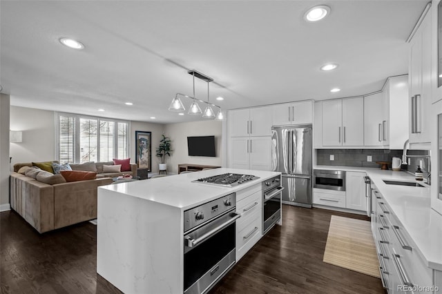 kitchen featuring white cabinets, stainless steel appliances, and sink