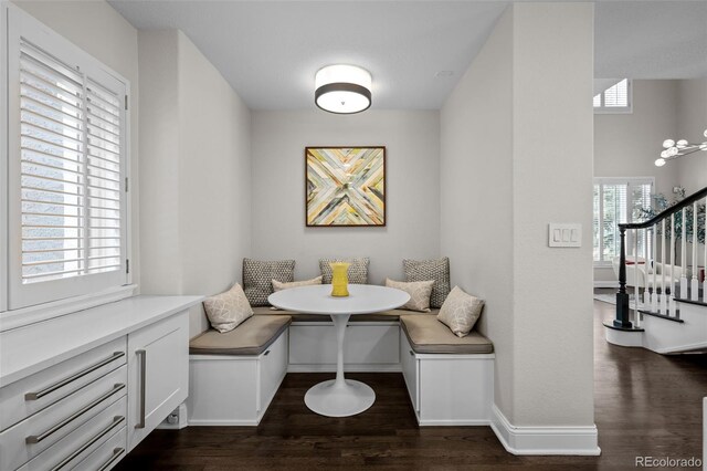 dining room featuring breakfast area and dark wood-type flooring