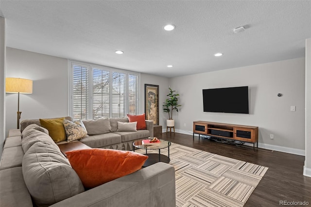 living room with a textured ceiling and dark wood-type flooring