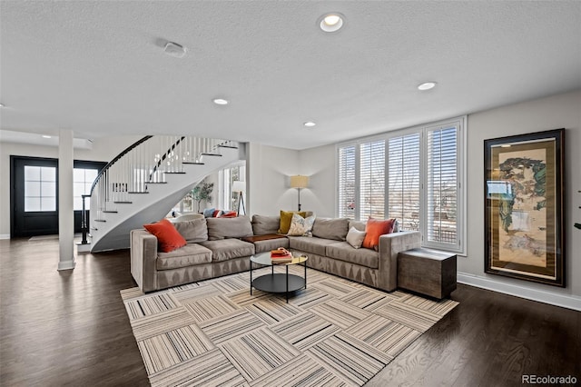 living room with wood-type flooring and a textured ceiling