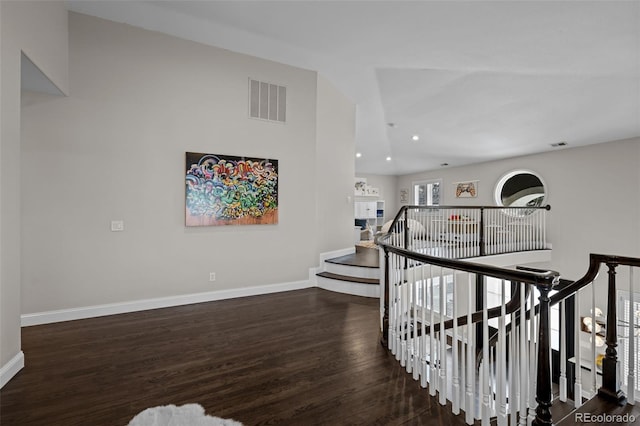 hallway with dark hardwood / wood-style flooring