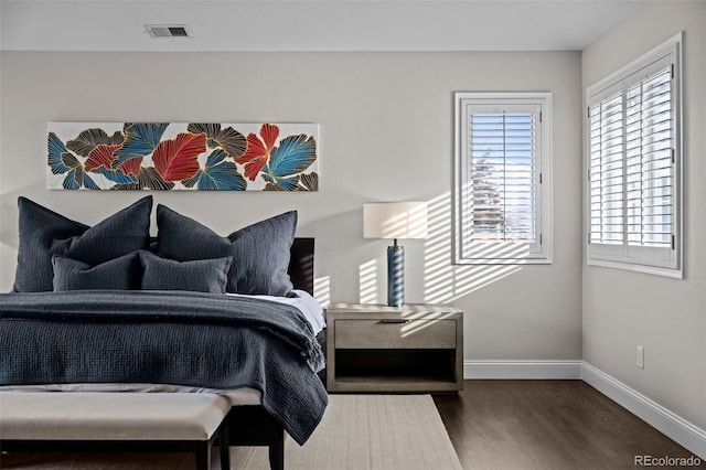 bedroom with dark wood-type flooring