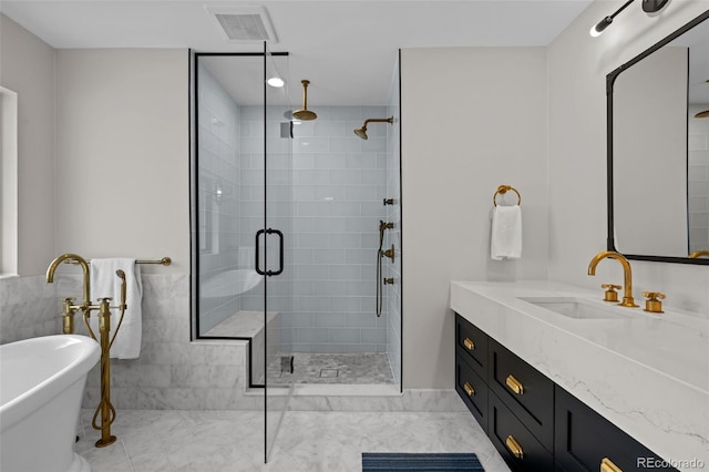 bathroom with vanity, separate shower and tub, and tile walls