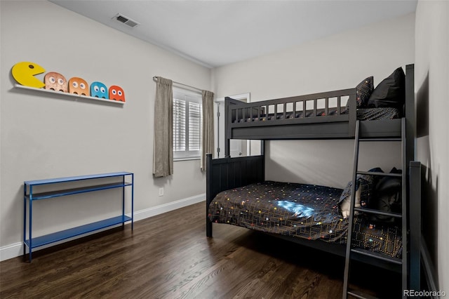 bedroom with dark wood-type flooring