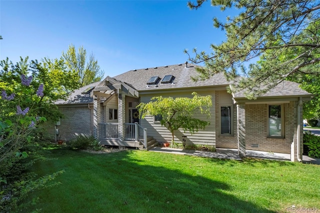 rear view of property with a lawn