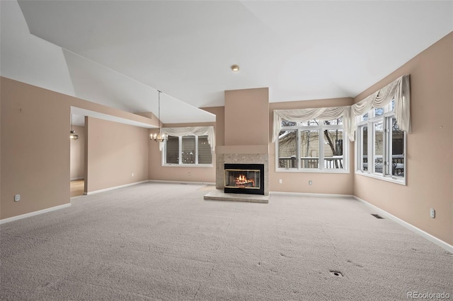 unfurnished living room featuring lofted ceiling, light carpet, and an inviting chandelier