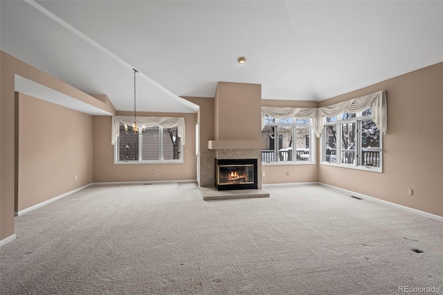 unfurnished living room with an inviting chandelier, light colored carpet, and lofted ceiling