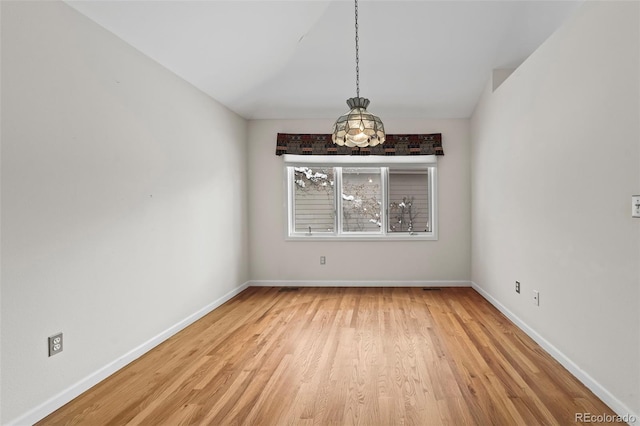 unfurnished dining area featuring light wood-type flooring