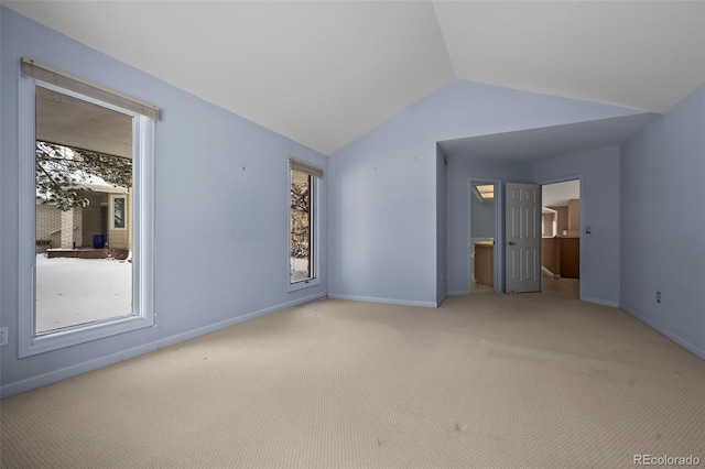 interior space with multiple windows, lofted ceiling, and carpet flooring