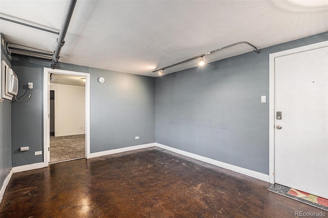 500 E 11th Ave Unit 102, Denver, CO 80203 - below grade area with track lighting, baseboards, and a wall mounted AC