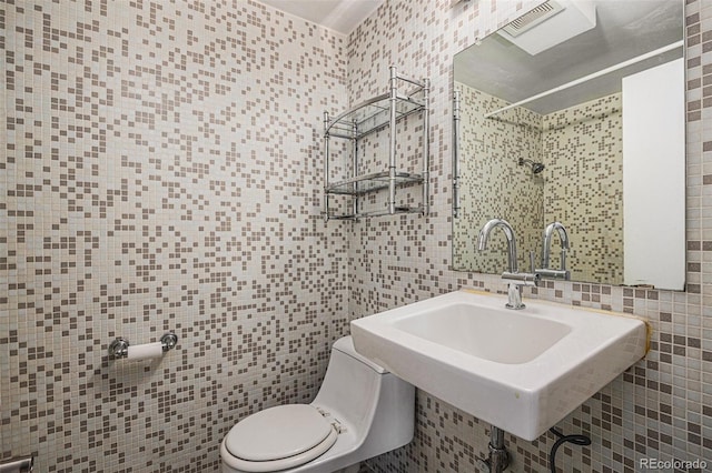 500 E 11th Ave Unit 102, Denver, CO 80203 - bathroom featuring tile walls, toilet, a tile shower, and a sink