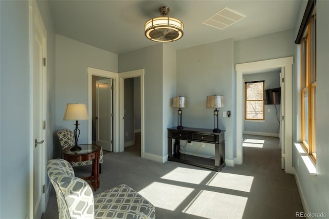 living area with baseboards, carpet, and visible vents