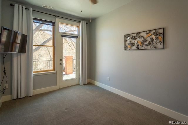 unfurnished room with baseboards, ceiling fan, carpet flooring, and visible vents