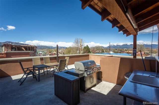 view of patio / terrace featuring a mountain view and a grill