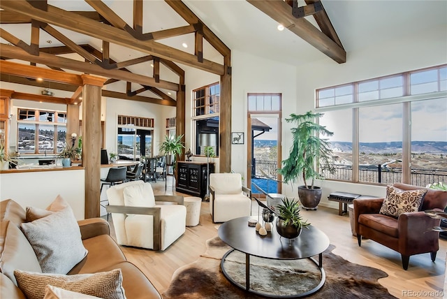 sunroom / solarium featuring lofted ceiling with beams