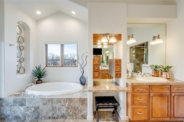 bathroom with walk in shower, vaulted ceiling, a bath, and vanity