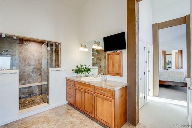 bathroom with a stall shower, connected bathroom, vanity, and a towering ceiling