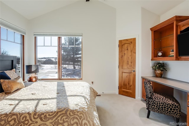 bedroom featuring light carpet, vaulted ceiling, and baseboards