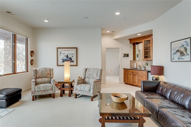 living room featuring indoor wet bar, recessed lighting, light colored carpet, and visible vents