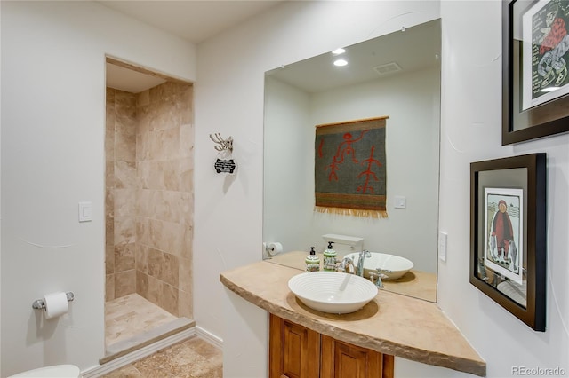 bathroom with a stall shower, visible vents, and vanity