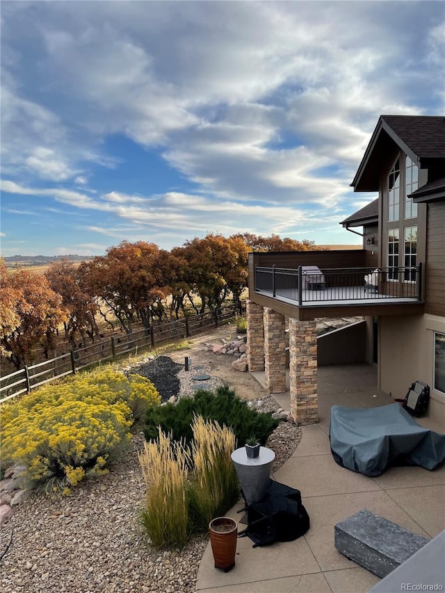 view of patio / terrace featuring a balcony and fence