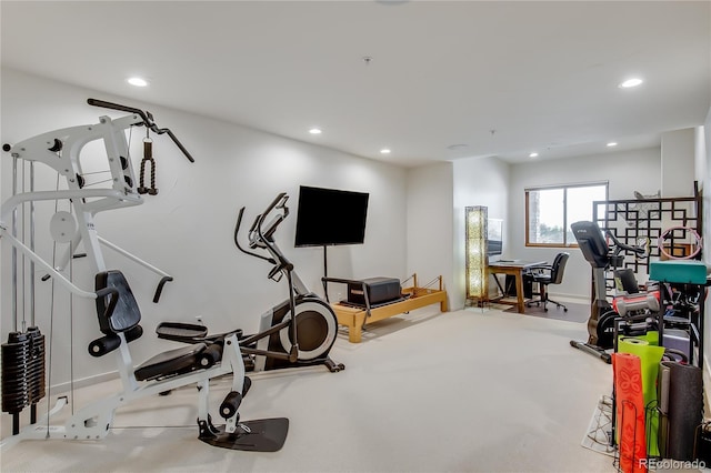 workout area featuring recessed lighting and baseboards