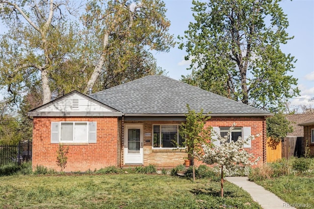 view of front facade featuring brick siding and a shingled roof