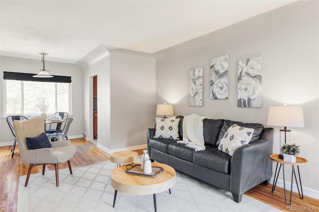 living area with light wood-style floors and baseboards
