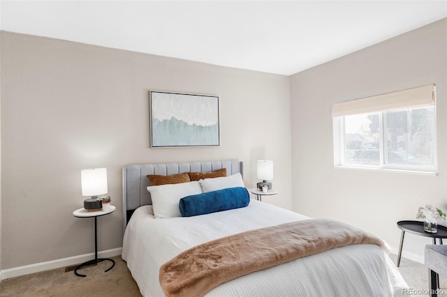 bedroom featuring light colored carpet and baseboards