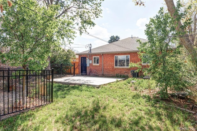 back of house with a patio, brick siding, and a shingled roof