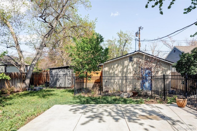view of yard featuring a patio area, an outbuilding, and a storage shed