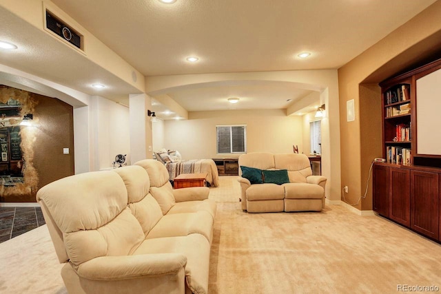14200 W 86th Pl, Arvada, CO 80005 - living area featuring arched walkways, baseboards, recessed lighting, and light carpet