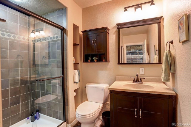 14200 W 86th Pl, Arvada, CO 80005 - bathroom featuring a textured wall, a tile shower, vanity, and toilet