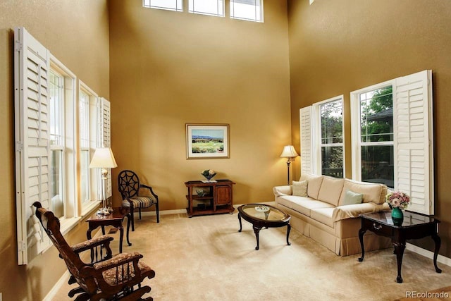 14200 W 86th Pl, Arvada, CO 80005 - carpeted living room featuring a high ceiling and baseboards