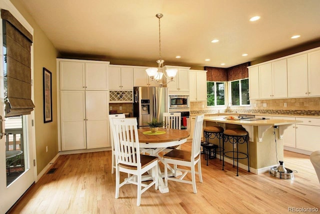 14200 W 86th Pl, Arvada, CO 80005 - dining area featuring a chandelier, light wood finished floors, recessed lighting, and baseboards