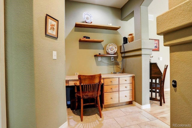 14200 W 86th Pl, Arvada, CO 80005 - office space featuring light tile patterned flooring, built in study area, a textured wall, and baseboards