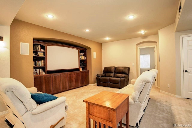 14200 W 86th Pl, Arvada, CO 80005 - living room with arched walkways, recessed lighting, light colored carpet, baseboards, and built in shelves