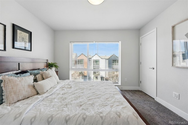 bedroom featuring baseboards and carpet floors