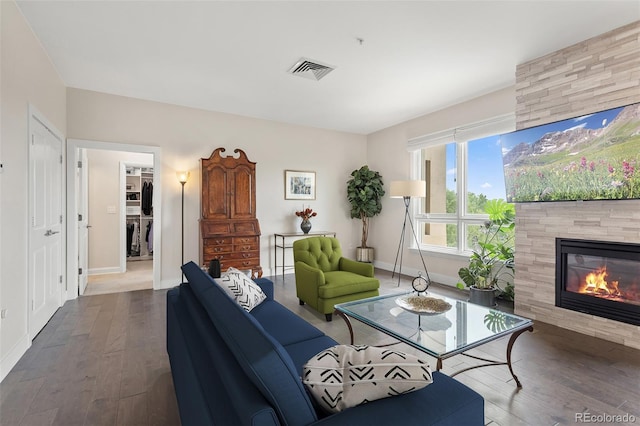 2500 E Cherry Creek S Drive 313, Denver, CO 80209 - living area featuring hardwood / wood-style flooring, a tiled fireplace, and baseboards