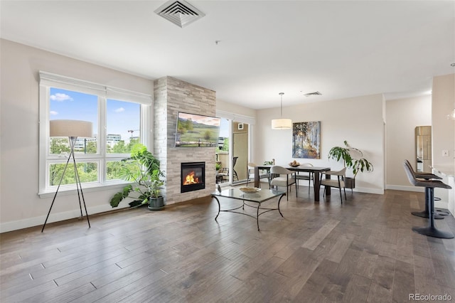 2500 E Cherry Creek S Drive 313, Denver, CO 80209 - living room with wood finished floors, baseboards, and a tiled fireplace