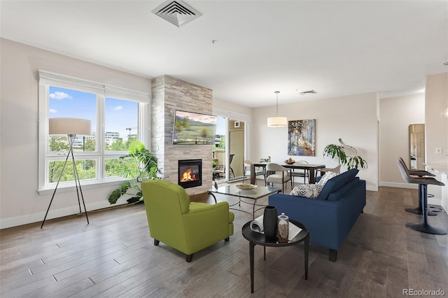 2500 E Cherry Creek S Drive 313, Denver, CO 80209 - living room featuring a fireplace, wood finished floors, and baseboards