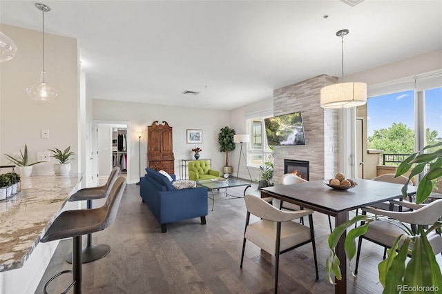 2500 E Cherry Creek S Drive 313, Denver, CO 80209 - dining space featuring a tile fireplace and wood finished floors